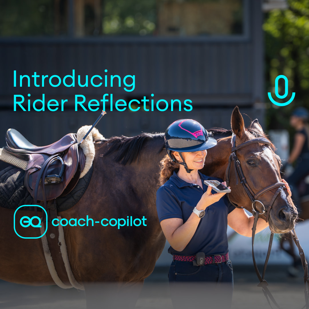 Woman in equestrian outfit next to horse speaking into a smartphone